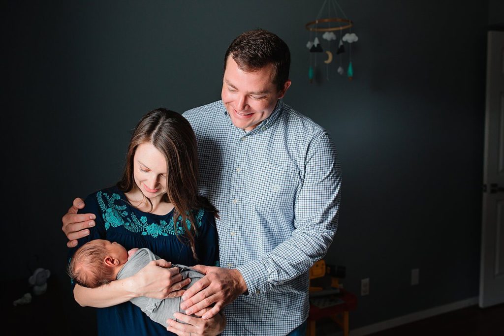 newborn photography session in dallas home with parents holding baby