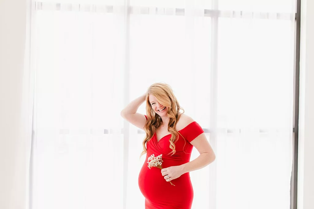 Pregnancy pictures in red gown with white flowers