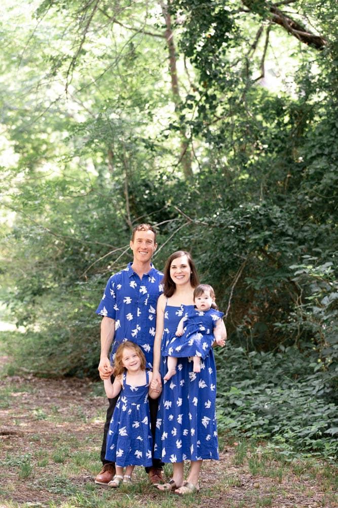 Family smiling in blue outfits at Prairie Creek Park in Richardson