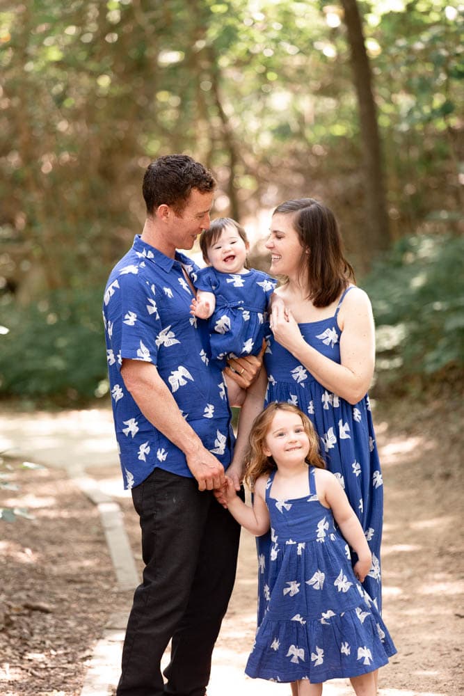 Family in matching blue outfits at a park