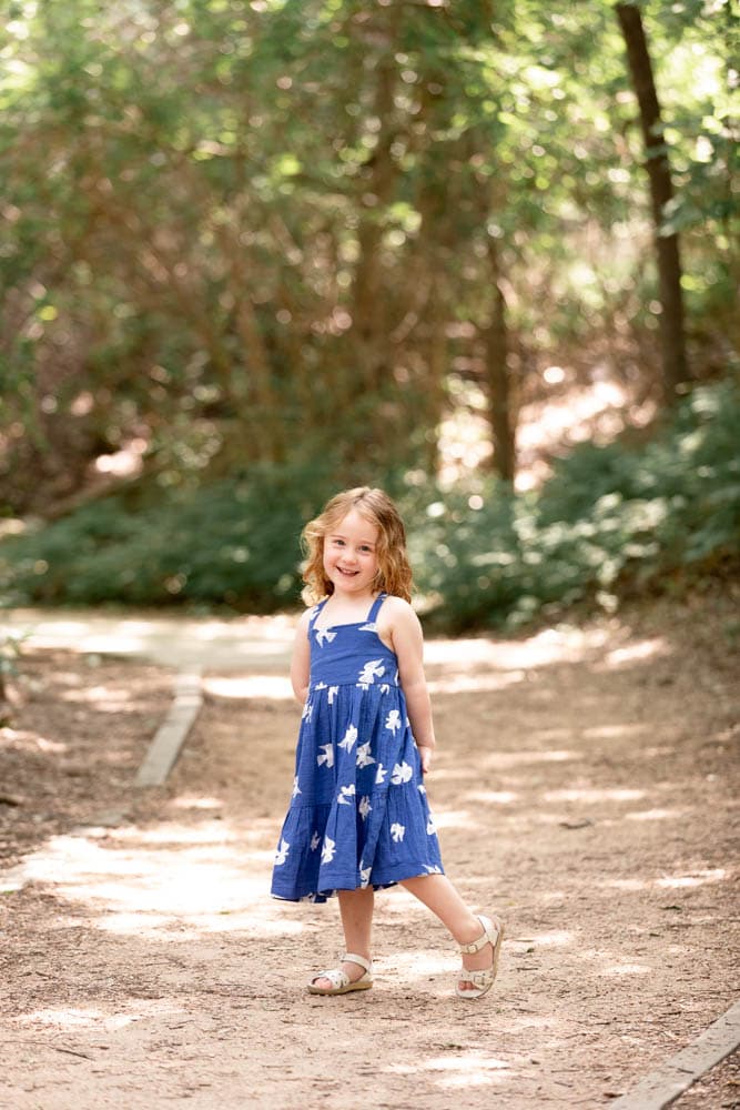 Young girl in blue dress at a park