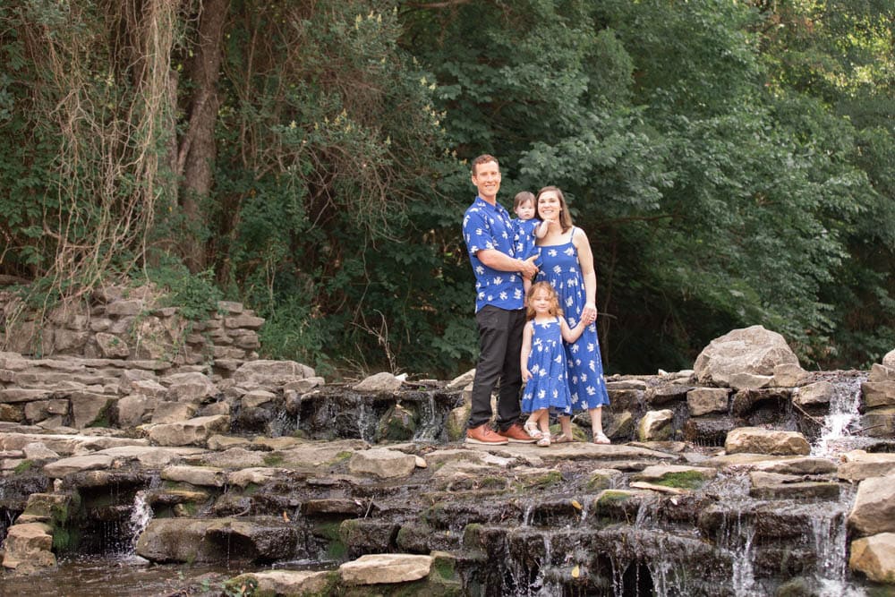 Young family posing on the waterfall at Prairie Creek Park